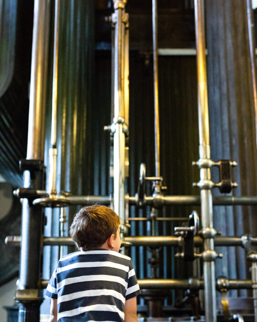 A boy looking at one of the Museum's stationary steam engines.