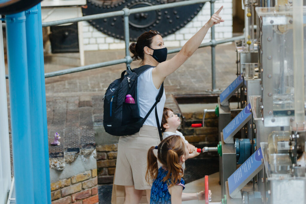 A family enjoying the water pumps in the Splash Zone.