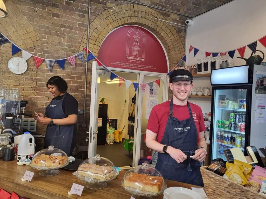 Two young people working in the Pump and Grind Coffee Shop.