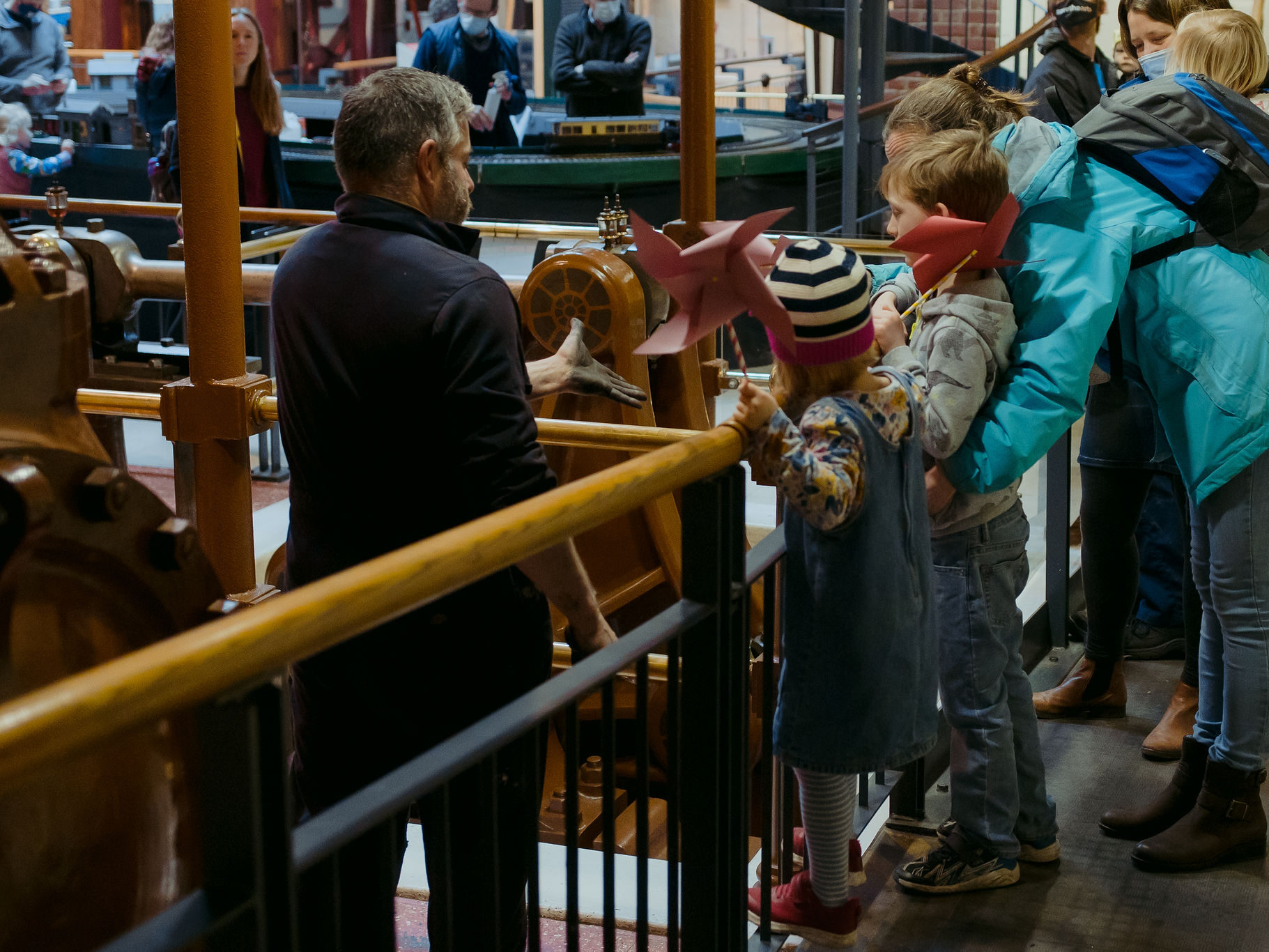 Stationary Steam Engine volunteer talking to families at a Steam Up event.